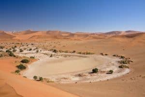 Sossusvlei, one of the Namib's major tourist attractions, is a salt and clay pan surrounded by large dunes. 